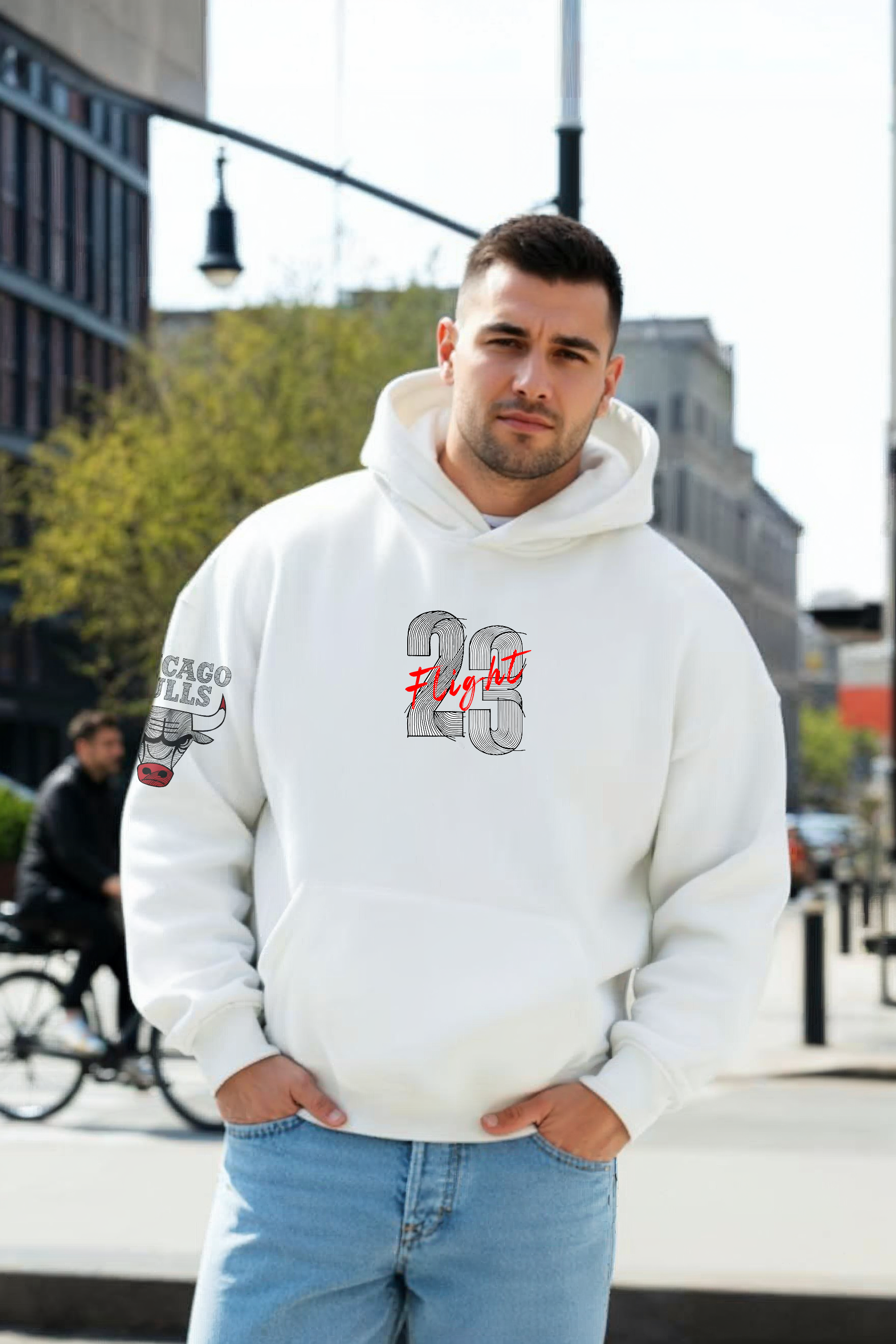 Man wearing a white hoodie with text and graphics, standing outdoors.