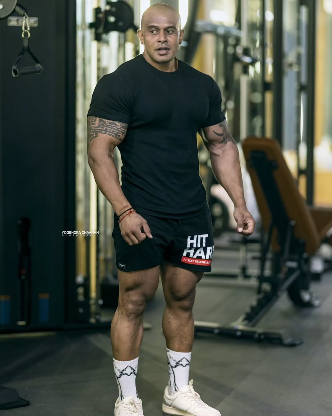Strong Soul men's black ribbed slim fit t-shirt and black training shorts with 'HIT HARD' graphic. Model in gym.